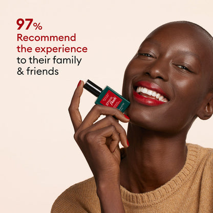 A smiling person with dark skin and red lipstick holds a Manucurist Gift Set near their face, next to an LED travel lamp. Red text on beige reads, "97% recommend the experience to family  friends.