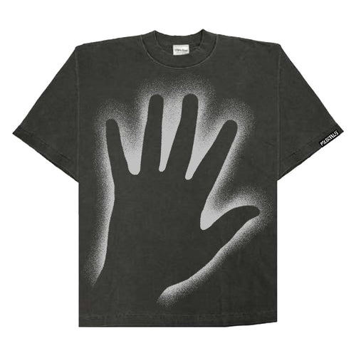 The Murals black oversized T-shirt showcases a bold, light gray spray-paint handprint at the center and features a small rectangular printed tag with text on the sleeve.