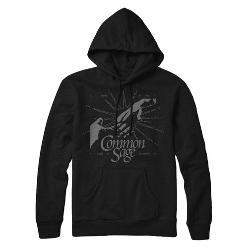 This black hoodie has two hands reaching out to touch each other surrounded by a sketch of a white light. The words "Common Sage" are near the center of the hoodie.