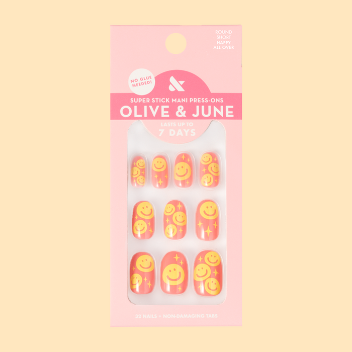 Happy All Over | Short | Round - Tab Press-On nails featuring pink base and cheerful yellow smiley face print for a bright mani look