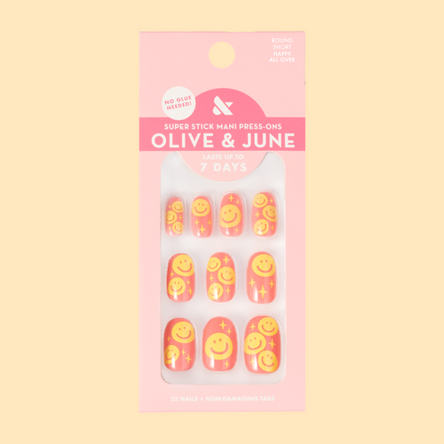 Happy All Over | Short | Round - Tab Press-On nails featuring pink base and cheerful yellow smiley face print for a bright mani look