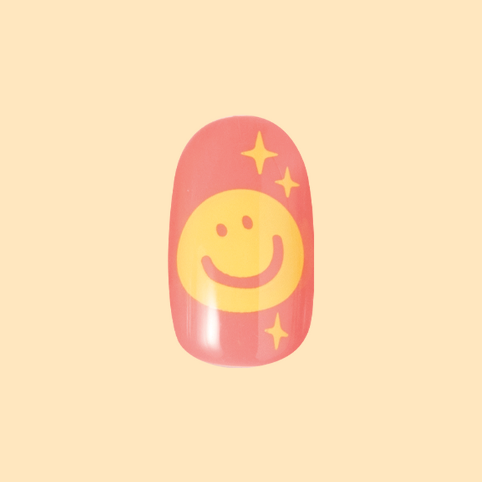 Happy All Over | Short | Round - Tab Press-On nail featuring cheerful yellow smiley face on pink base for a fun mani look