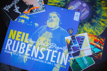 This image shows the Neil Rubenstein vinyl and jackets spread out over a dark table.