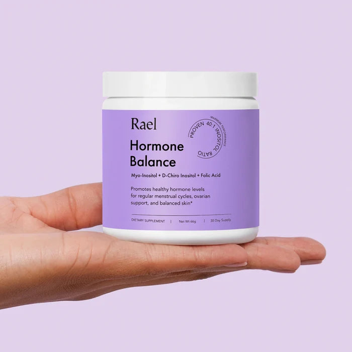 Hormone Balance Supplement bottle being held in an open hand