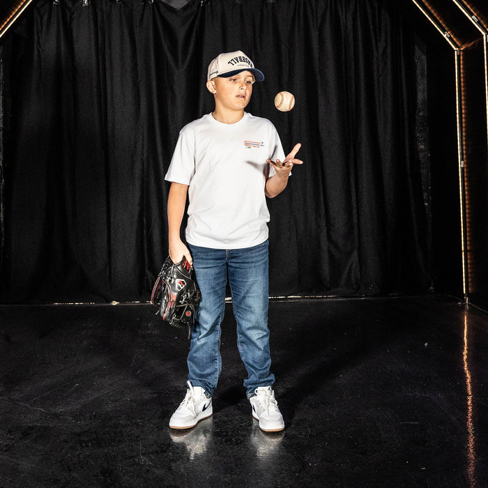 Youth model wearing white youth graphic tee with "Houston Astros Drip" design