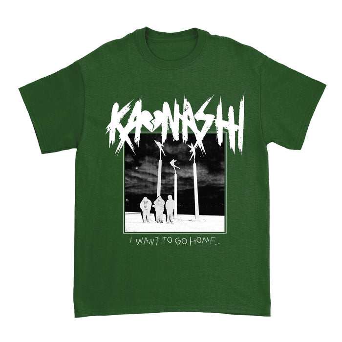 On a green shirt the "Kaonashi" with a broken heart as an "o" are in white are above an image of three members standing in a black and white field overlooking the night sky. The words "I want to go home" are below this image.