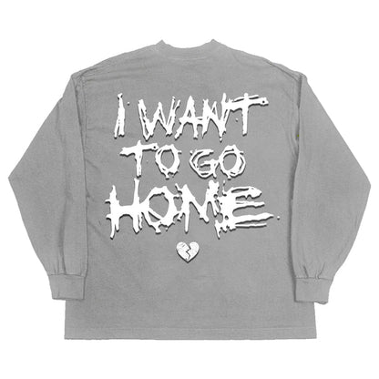 On the back of the gray top, the words "I want to go home" are in big white letters, along with a broken heart icon.