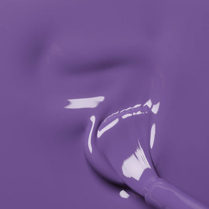 A close-up of a paintbrush coated in Manucurist’s Iris, a glossy purple gel polish, blending into a smooth, shiny surface with subtle blue undertones and visible reflections.