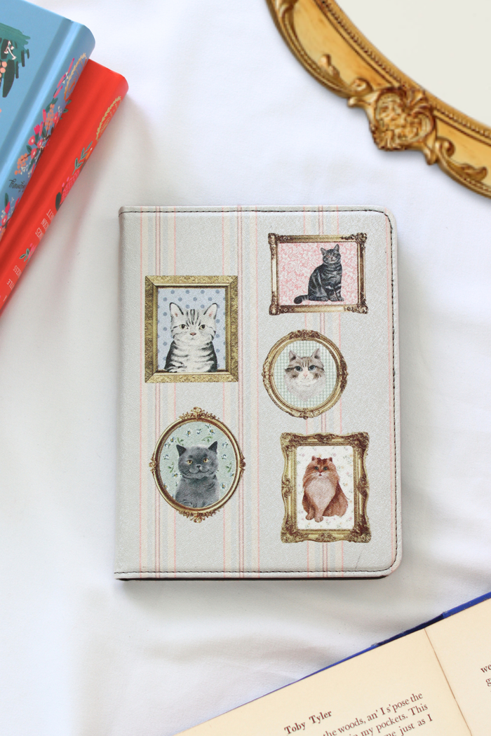 Kindle case with cat illustrations on a white surface