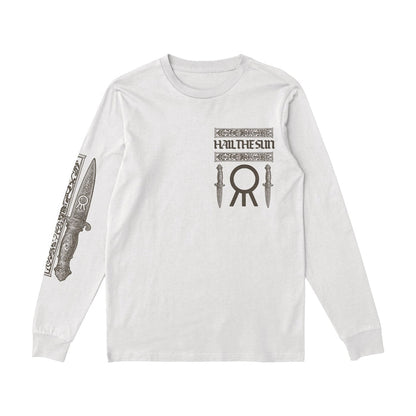 A white long-sleeve Hail The Sun shirt with the bands name and two knife graphics on the chest, a large circular symbol below, and a detailed dagger design on the right sleeve.