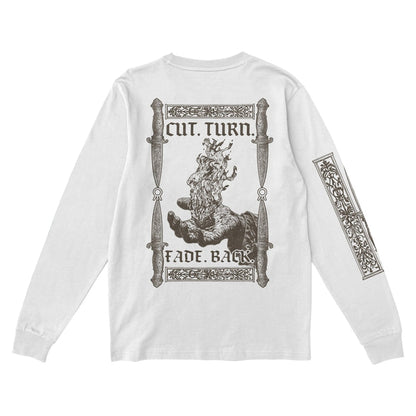 Hail The Sun white long-sleeve shirt with a bold back graphic: hands holding a flaming knife, ornate borders, swords, “CUT. TURN. FADE. BACK.” text. Matching artwork also decorates the right sleeve.