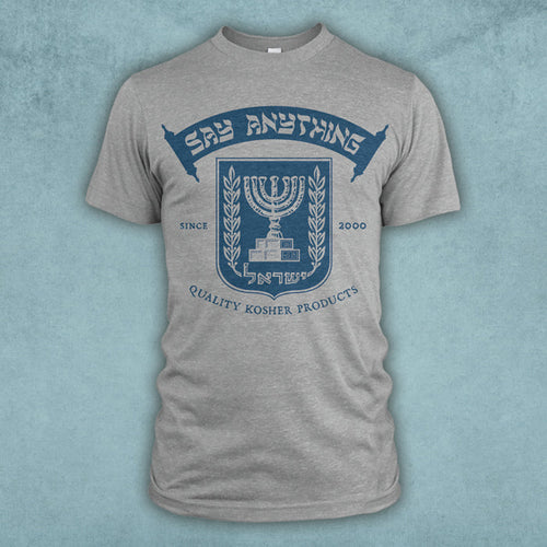 A grey t-shirt has a blue emblem of a menorah with the words "Say Anything" printed on a scroll above it. The words "Quality Kosher Products" are below it.