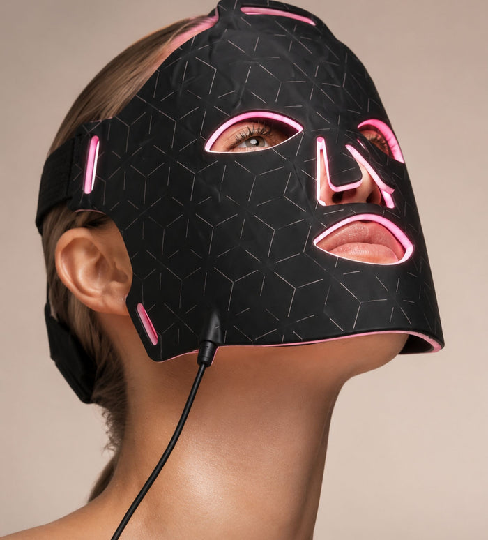Woman wearing Luminmax LED clinic-grade red light therapy face mask for anti-aging skin rejuvenation