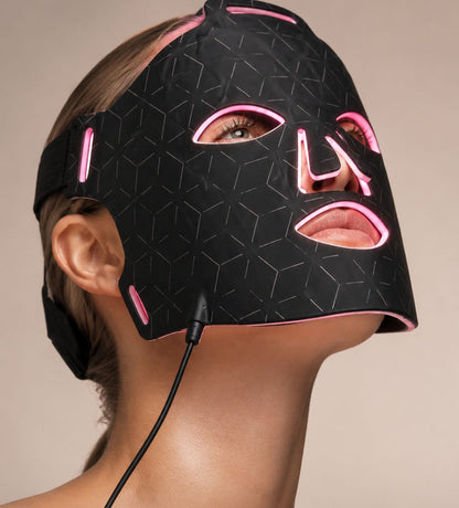 Woman wearing Luminmax LED clinic-grade red light therapy face mask for anti-aging skin rejuvenation