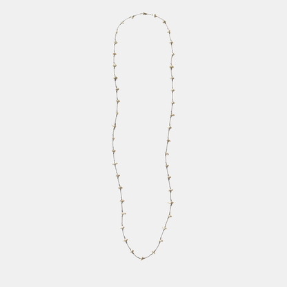 Long keshi pearl necklace with small white teardrop pearls on a thin gold-tone chain