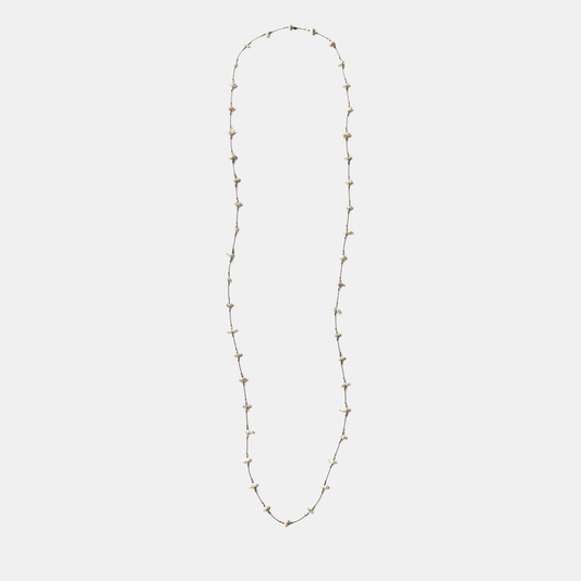 Long keshi pearl necklace with small white teardrop pearls on a thin gold-tone chain