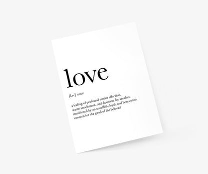 lifestyle shot of a valentine’s day card with the word “love” in black handwriting and it's definition