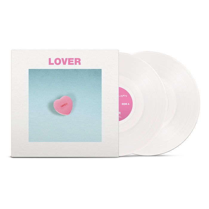 The Sound Of Animals Fighting’s Lover The Lord Has Left Us is a vinyl set with two opaque white discs. The cover shows a pink candy heart reading “Lover” on a blue background, white border, and the title in pink uppercase at the top.