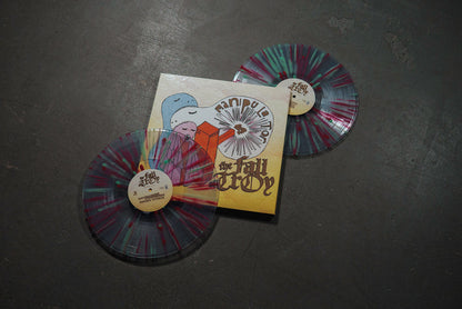 Two vibrant splatter vinyl records flank a sleeve featuring playful cartoon art and "Manipulator" by The Fall of Troy—a striking limited edition Double LP collectible from The Fall of Troy.