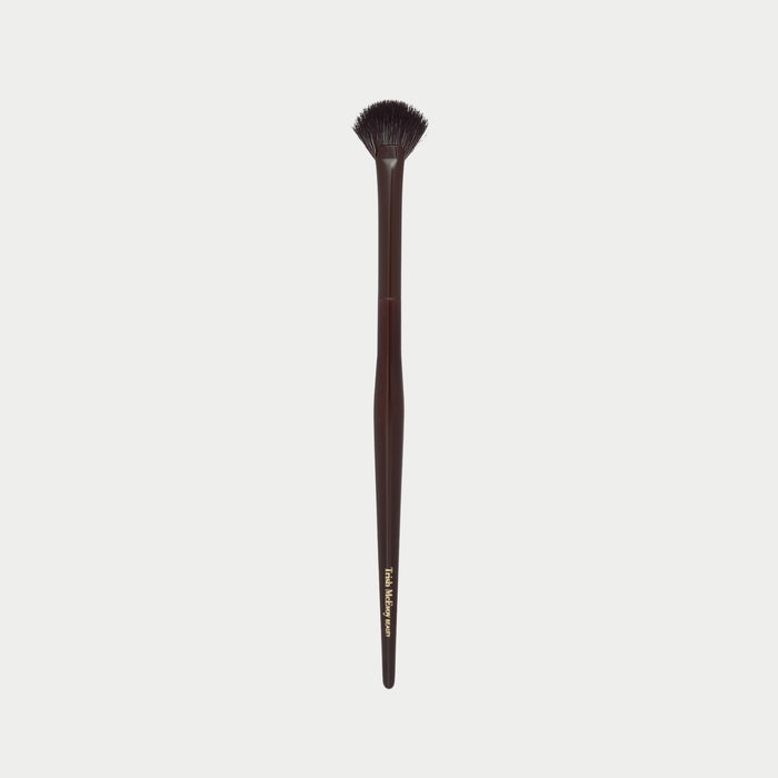 Makeup brush 63 with a wooden handle on a white background