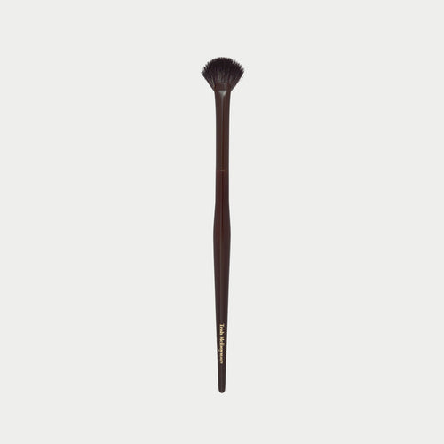 Makeup brush 63 with a wooden handle on a white background