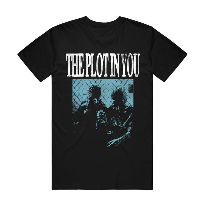 Black graphic tee by The Plot In You with the band's name in bold white letters above a blue-hued image of two people, inspired by "My Old Ways," sitting in front of a chain-link fence.