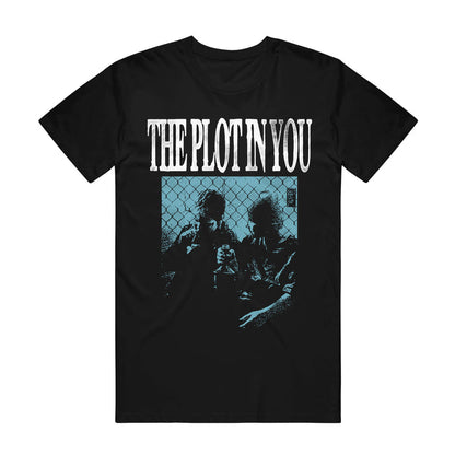 Black graphic tee by The Plot In You with the band's name in bold white letters above a blue-hued image of two people, inspired by "My Old Ways," sitting in front of a chain-link fence.