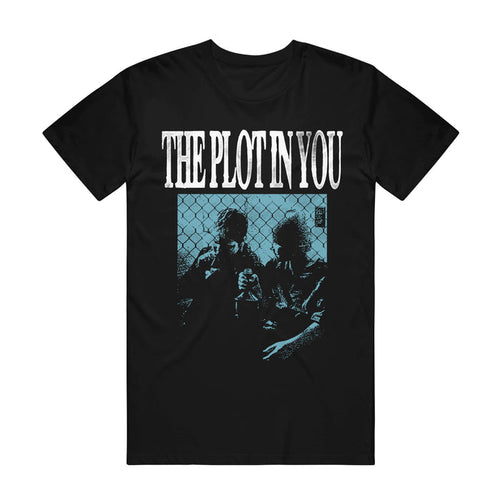 Black graphic tee by The Plot In You with the band's name in bold white letters above a blue-hued image of two people, inspired by "My Old Ways," sitting in front of a chain-link fence.