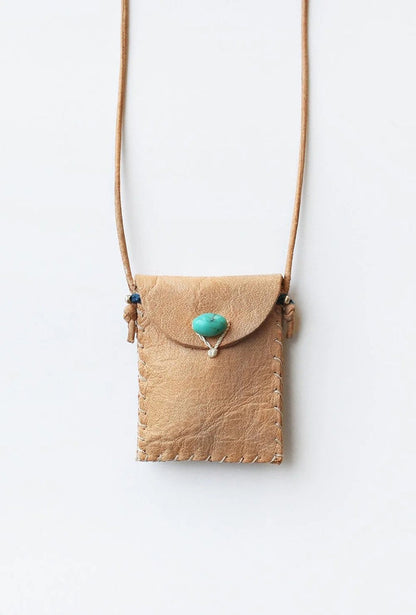 Tan leather amulet pouch with flap, turquoise stone, and side tie cords
