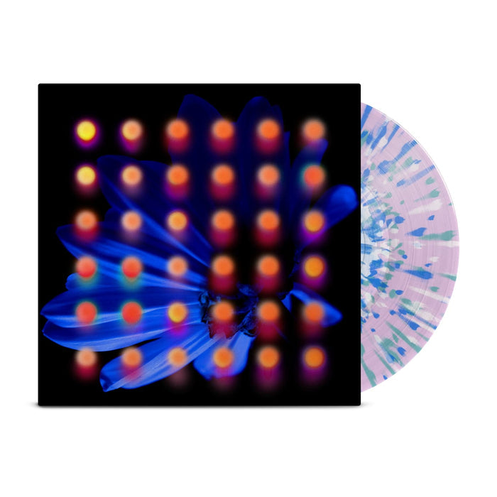 Clear lavender base with blue, teal, and white splattered vinyl peeks out of a black jacket with a dark blue flower background. There are orange and pink dots layered over the image of the flower.