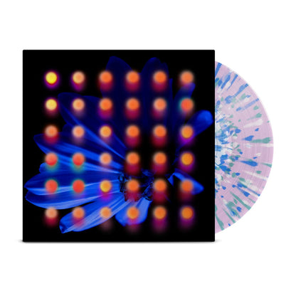Clear lavender base with blue, teal, and white splattered vinyl peeks out of a black jacket with a dark blue flower background. There are orange and pink dots layered over the image of the flower.