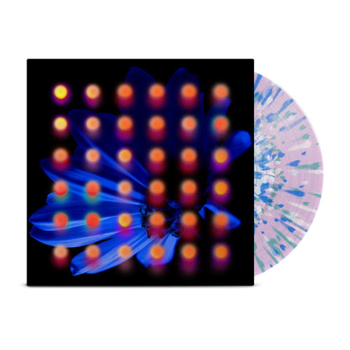 Clear lavender base with blue, teal, and white splattered vinyl peeks out of a black jacket with a dark blue flower background. There are orange and pink dots layered over the image of the flower.