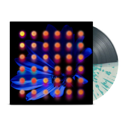 Half grey/half white with teal splattered vinyl peeks out of a black jacket with a dark blue flower background. There are orange and pink dots layered over the image of the flower.