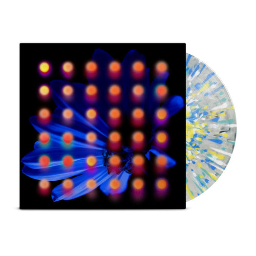 Light grey marble splattered with yellow, white, blue, and teal vinyl peeks out of a black jacket with a dark blue flower background. There are orange and pink dots layered over the image of the flower.