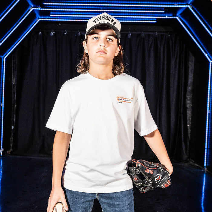 Youth model wearing white youth graphic tee with "New York Mets Drip" design