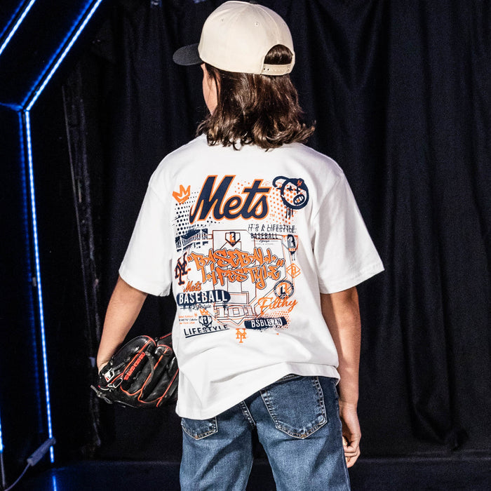 Youth model wearing white youth graphic tee with "New York Mets Drip" design