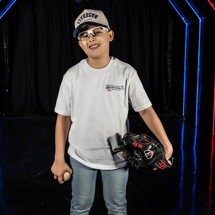Youth model wearing white youth graphic tee with "New York Yankees Drip" design