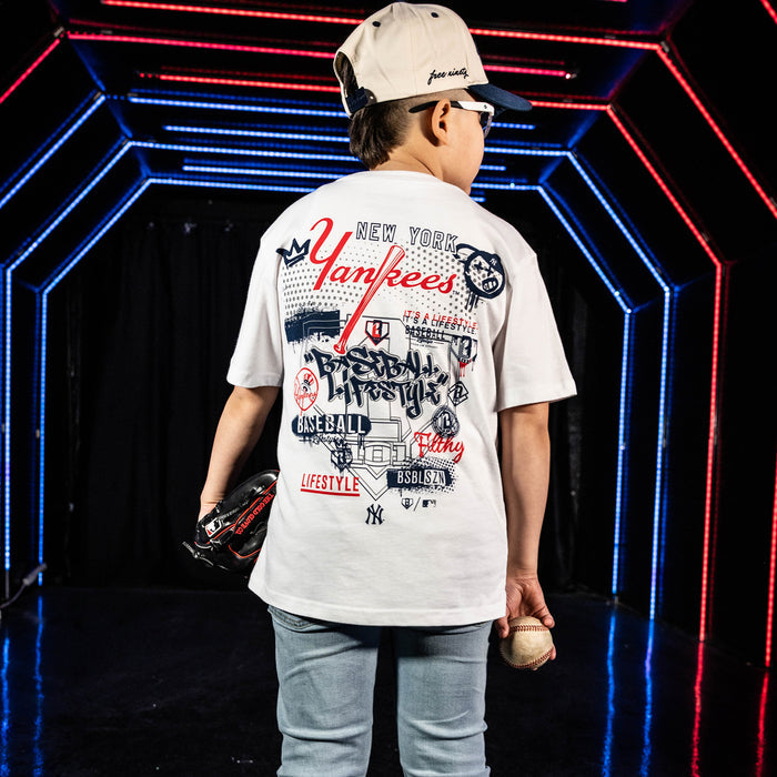 Youth model wearing white youth graphic tee with "New York Yankees Drip" design