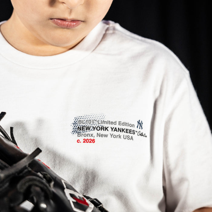 Youth model wearing white youth graphic tee with "New York Yankees Drip" design