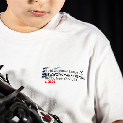 Youth model wearing white youth graphic tee with "New York Yankees Drip" design