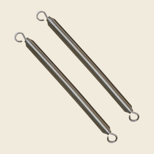 Pair of nickel plated reformer springs with hooked ends on a cream background.