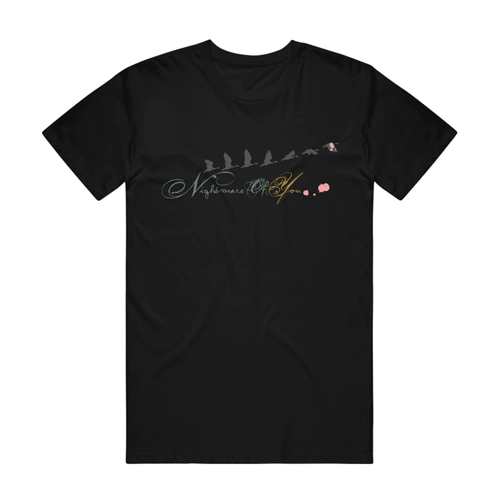 Black printed t-shirt by Nightmare Of You on Comfort Colors, featuring silhouetted birds in flight above "Nightmare Play" in cursive and two small pink flowers on the right side of the design.