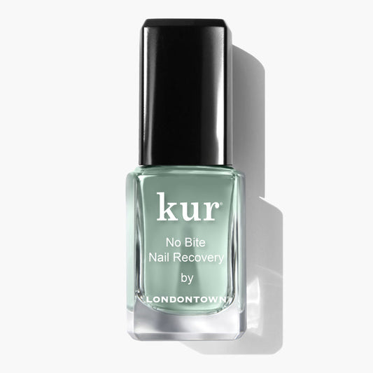 A bottle of LONDONTOWN No Bite Nail Recovery polish, featuring a black cap and green liquid inside, is designed to promote healthy-looking nails and encourage better habits.