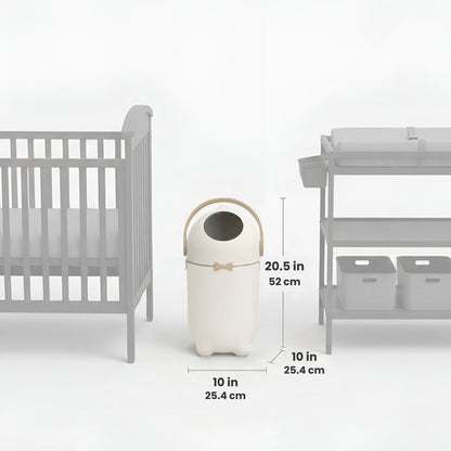 iTouchless Odor-Free Diaper Pail shown centered between a crib and a changing table, with labeled dimensions. The pail measures 20.5 inches tall (52 cm) and 10 inches wide and deep (25.4 cm), illustrating its compact size and nursery-friendly fit.
