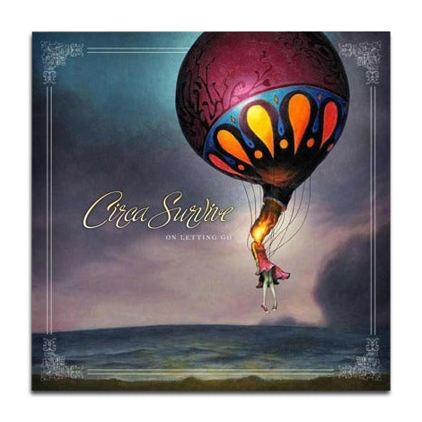 A surreal painting of a figure hanging from a large, ornate hot air balloon over a dusk landscape. “Circa Survive” appears in elegant cursive near the center left, evoking the ethereal vibe of this iconic music album.