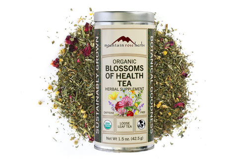 Mountain Rose Herbs Organic Blossoms of Health Tea canister with tea leaves and flowers on a white background, Raven's Cauldron, 6 N. Sandusky St, Delaware, OH 43015