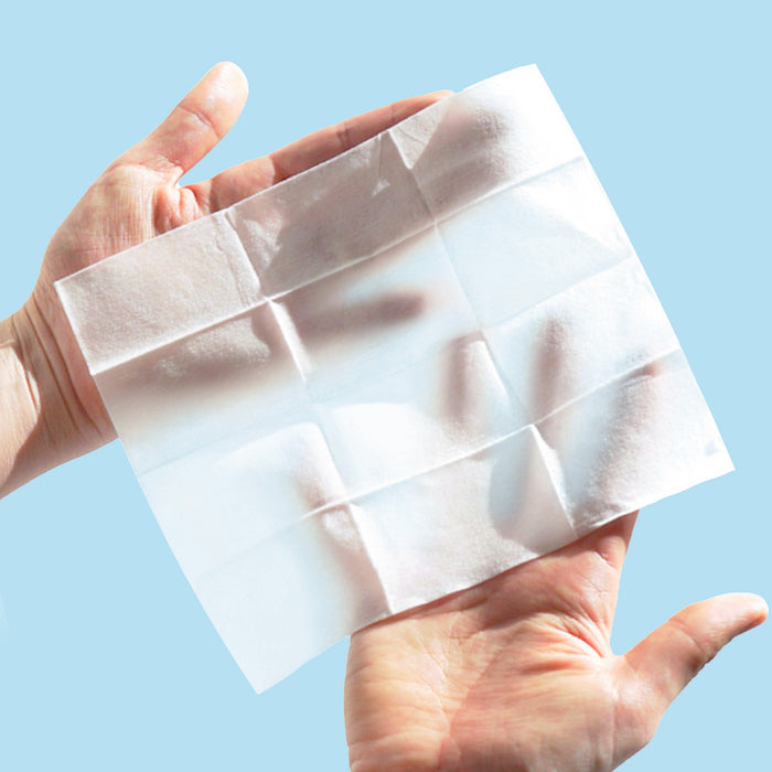 Model holding a Rael Organic Cotton Body Wipe in hands.