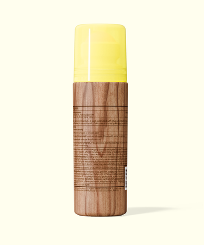Back view of Sun Bum Original SPF 50 Sunscreen Roll-On Lotion with wood-textured bottle and yellow cap