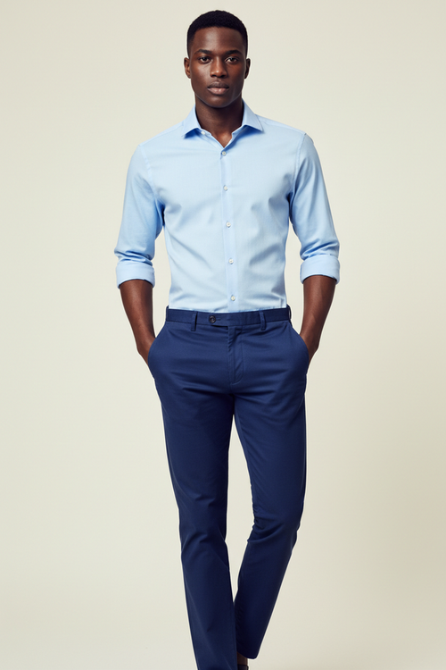 Full length model wearing Monza Sky Blue Dress Shirt and Khaki Navy Blue Pants on cream background