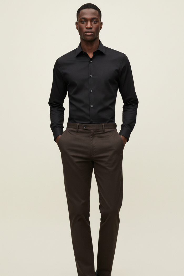Full length model wearing Verso Black Dress Shirt and Khaki Dark Brown Pants on cream background